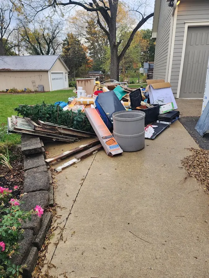 Dumpster being loaded with debris for 3 Yard Dumpster Rental in Fort Riley